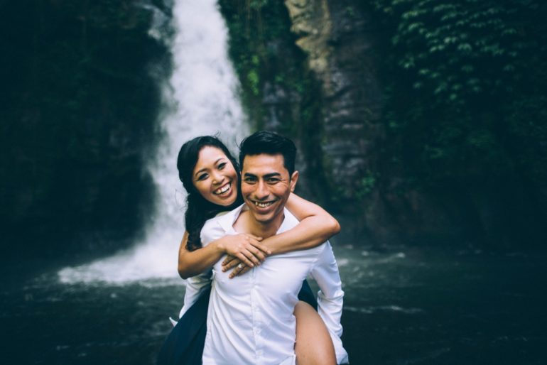 bali waterfall couple back hug