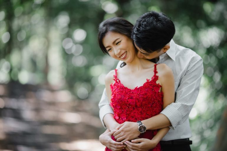 Young lovely couple boyfriend and girlfriend posing together with broad  smile while man hugging woman happily, over white background Stock Photo |  Adobe Stock