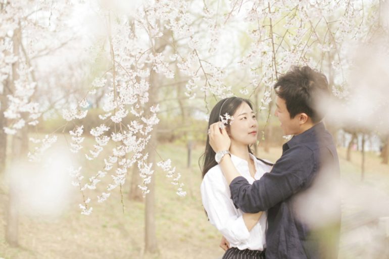 Elegant couple pose outdoors. Happy couple in a city center. Romantic photo  of a hugging couple. Young couple in love. Relationship concept - photo of  beautiful couple Stock Photo | Adobe Stock