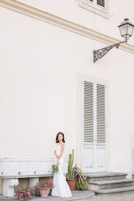 bride poses while holding her arm