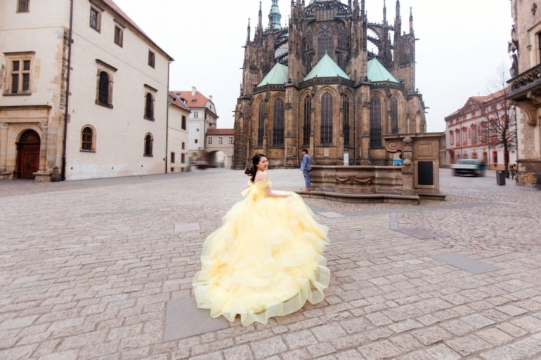 bride in yellow ballgown on the streets of prague