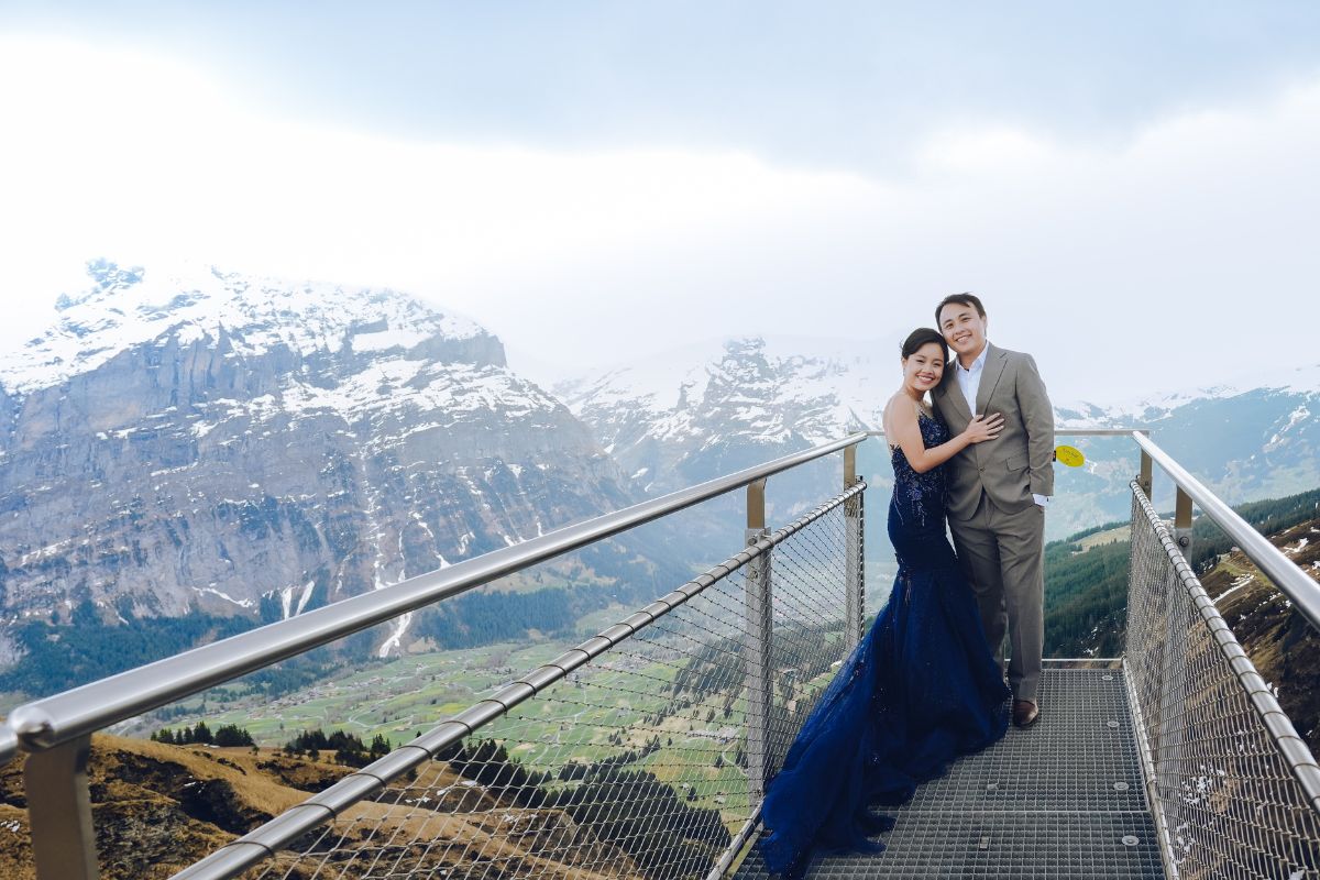 Couple having a pre-wedding photoshoot at First Cliff Walk in Grindelwald, overlooking the Swiss Alps.