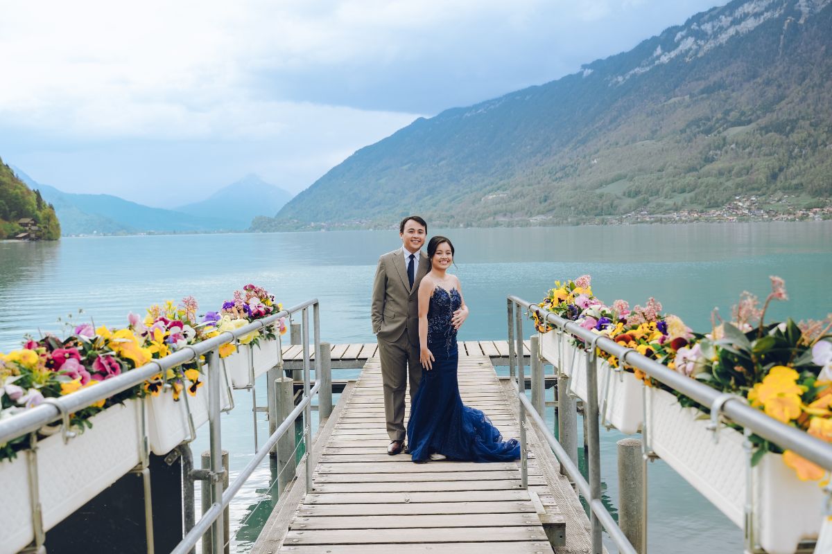 Pre-wedding couple by the lakeside in Iseltwald with turquoise Lake Brienz and Swiss Alps in the background