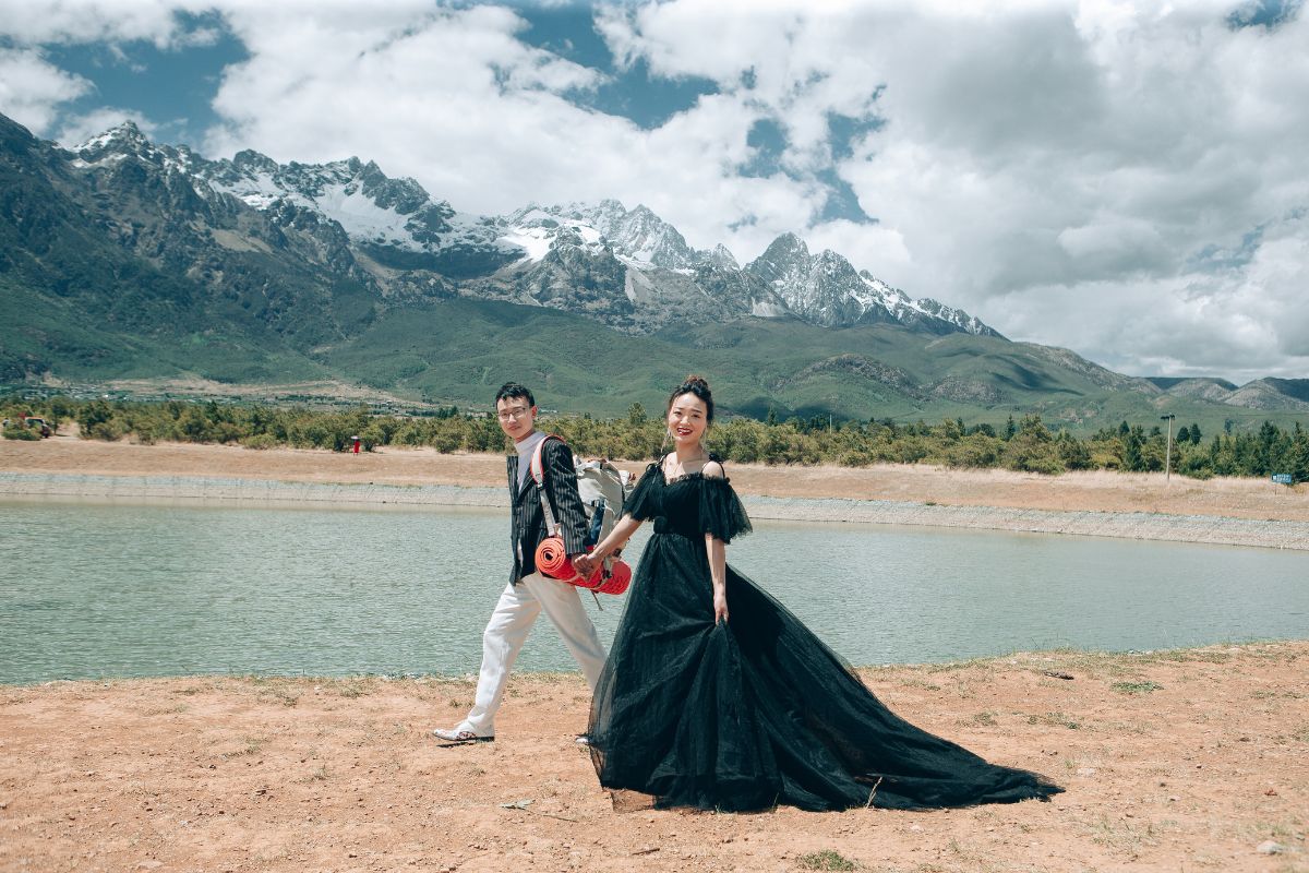 Couple having a pre-wedding photoshoot at Spruce Meadow with Jade Dragon Snow Mountain in the background
