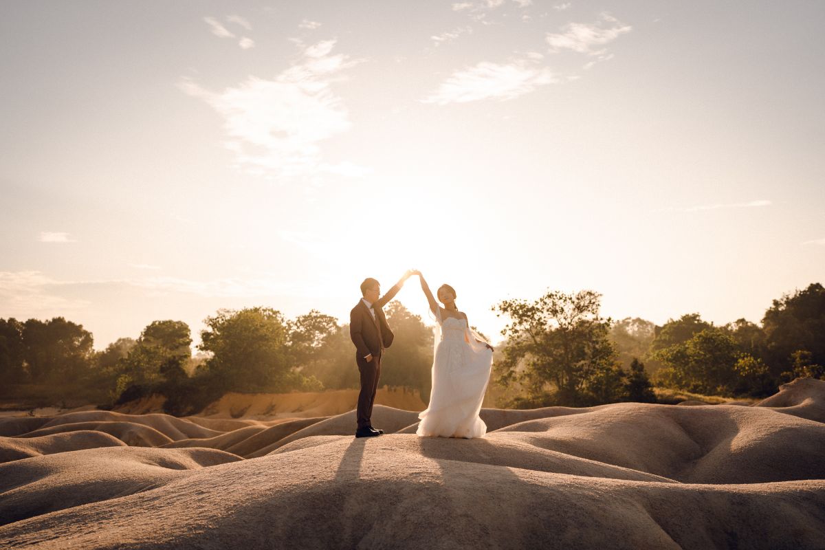 Couple having a pre-wedding photoshoot on the sand dunes of Bintan