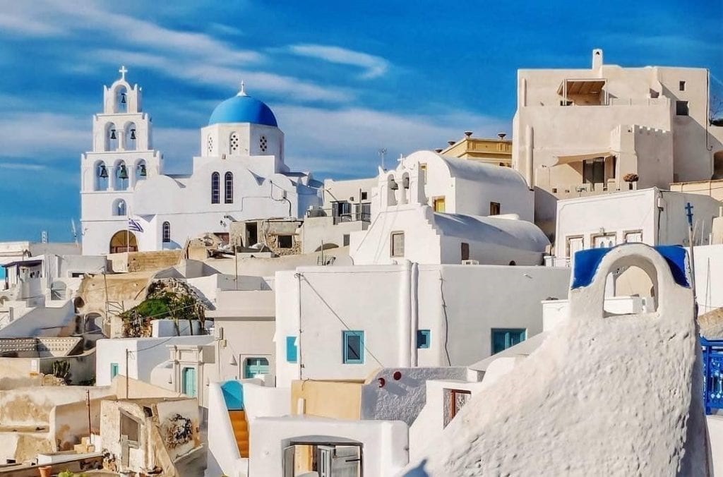 Scenic view of Pyrgos Village in Santorini with whitewashed houses and narrow stone alleys.